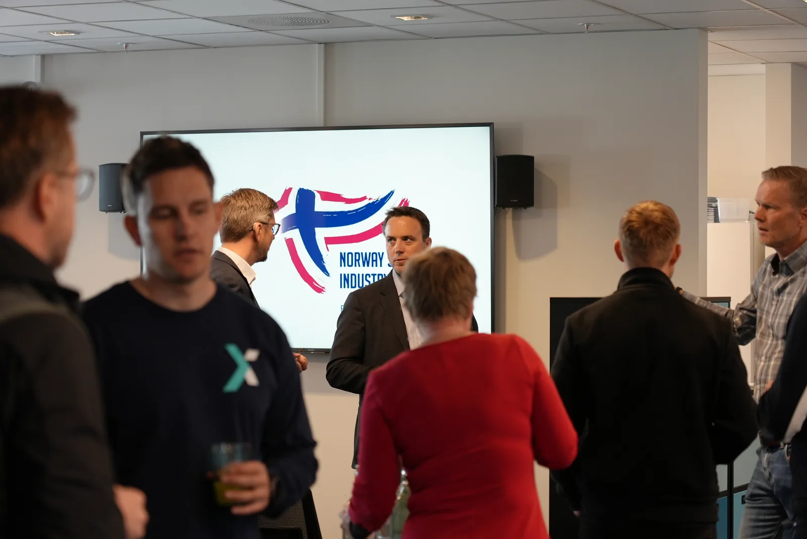 Participants talking at a sports industry network gathering.